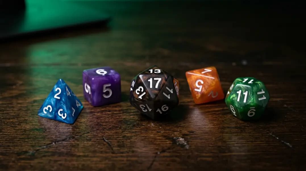 Online dice roller interface showing five polyhedral dice of different types arranged on a dark gaming table surface, including a D4, D6, D8, D12, and D20, with the D20 showing a result of 17 in large numbers, a roll button visible at the bottom, and individual die result labels displayed below each die icon Online dice roller interface showing five polyhedral dice of different types arranged on a dark gaming table surface, including a D4, D6, D8, D12, and D20, with the D20 showing a result of 17 in large numbers, a roll button visible at the bottom, and individual die result labels displayed below each die icon